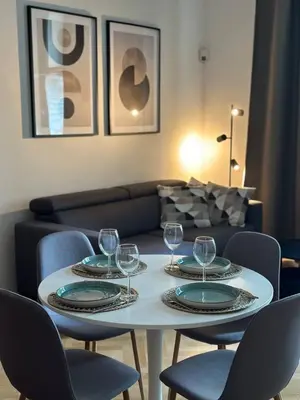 a table with wine glasses on it in a living room at Spacious Elegance - A Central Gem in Prague