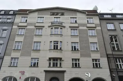 a building with a clock on the top of it at Spacious Elegance - A Central Gem in Prague