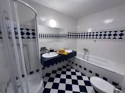 a bathroom with a sink and a shower and a toilet at Spacious Elegance - A Central Gem in Prague