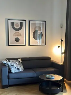 a living room with a couch and a table at Spacious Elegance - A Central Gem in Prague