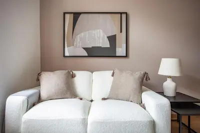 a living room with a white couch and a lamp at Blueground Vršovice furnished equipped PRG-5 in Prague