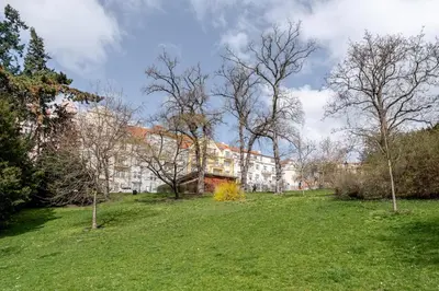 a grassy field with a building in the background at Blueground Vršovice furnished equipped PRG-5 in Prague