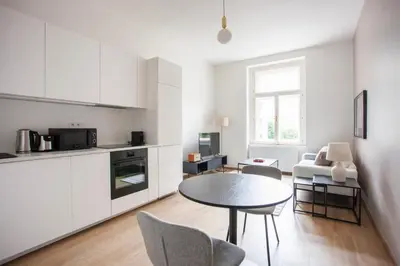 a kitchen with a table and chairs in a room at Blueground Vršovice furnished equipped PRG-5 in Prague