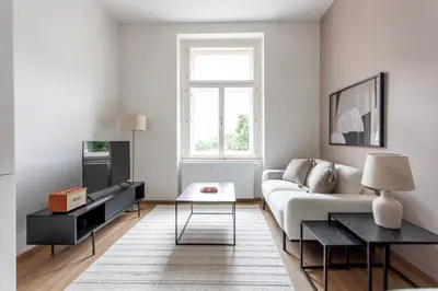 a living room with a couch and a table at Blueground Vršovice furnished equipped PRG-5 in Prague