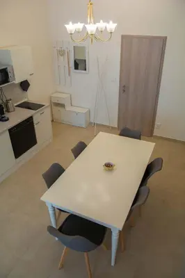 a white table and chairs in a kitchen at City Centre Apartment with Parking in Prague