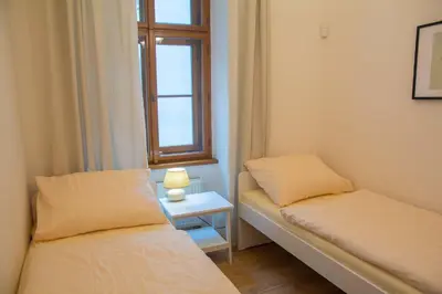 a small room with two beds and a window at City Centre Apartment with Parking in Prague