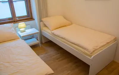 a small room with two beds and a window at City Centre Apartment with Parking in Prague