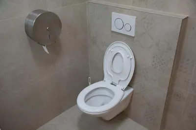 a bathroom with a white toilet in a stall at City Centre Apartment with Parking in Prague