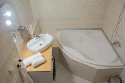 a bathroom with a white tub and a sink at City Centre Apartment with Parking in Prague