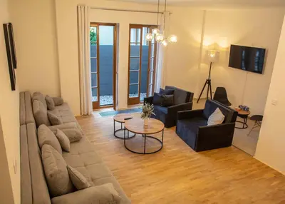 a living room with a couch and chairs and a table at New City Centre Garden Apartment - Central Location in Prague
