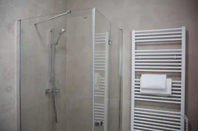 a bathroom with a shower with a glass door at New City Centre Garden Apartment - Central Location in Prague