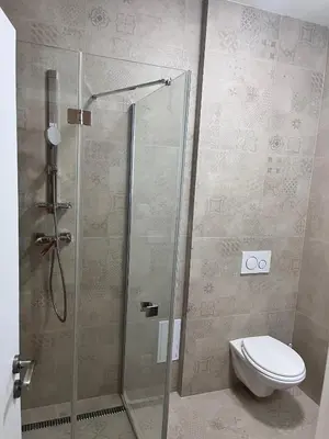 a bathroom with a shower with a toilet in it at New City Centre Garden Apartment - Central Location in Prague