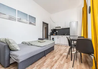 a bedroom with a bed and a table and chairs at Crimson Charm in Prague