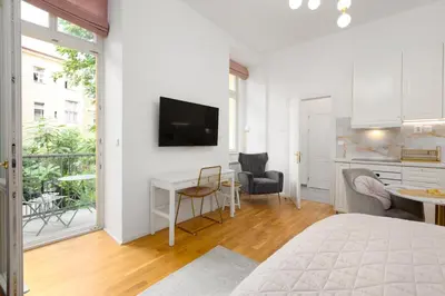 a bedroom with a bed and a desk with a television at Quiet and stylish apartment near Wenceslas Square in Prague