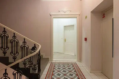 a hallway with a staircase with a white door at Quiet and stylish apartment near Wenceslas Square in Prague