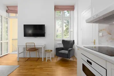 a kitchen with a table and chairs and a tv at Quiet and stylish apartment near Wenceslas Square in Prague