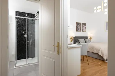 a bathroom with a shower with a glass door at Quiet and stylish apartment near Wenceslas Square in Prague
