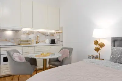 a bedroom with a bed and a table and chairs at Quiet and stylish apartment near Wenceslas Square in Prague