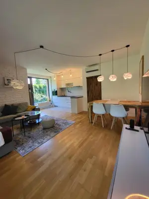 a living room and kitchen with a table and chairs at Apartmán v Praze 6, Sedlec in Prague