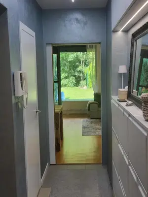 a hallway with a door leading to a living room at Apartmán v Praze 6, Sedlec in Prague