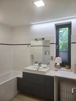 a bathroom with a sink and a tub and a window at Apartmán v Praze 6, Sedlec in Prague