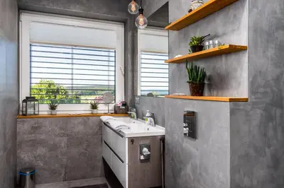 a bathroom with a sink and a window at Rezidence Malá Louka in Kublov