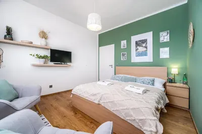 a bedroom with a bed and two chairs at Rezidence Malá Louka in Kublov