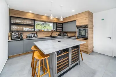 a kitchen with a large island with wine racks at Rezidence Malá Louka in Kublov