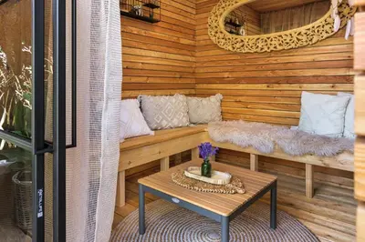 a porch with a bench and a table at Rezidence Malá Louka in Kublov