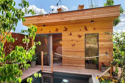 a tiny house with a porch with birds on it at Rezidence Malá Louka in Kublov