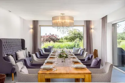 a dining room with a long table and chairs at Rezidence Malá Louka in Kublov