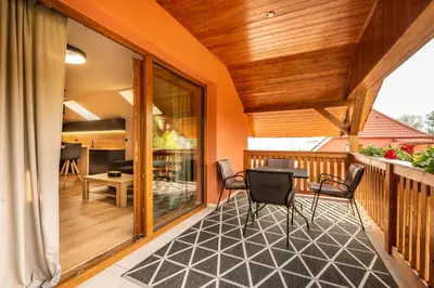 a screened porch with a table and chairs on it at Penzion U Mě in Obora