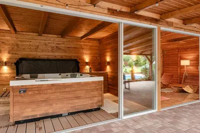 a sauna with a tub in a wooden house at Penzion U Mě in Obora
