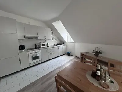 a kitchen with white appliances and a wooden table at U Drahusky in Prague