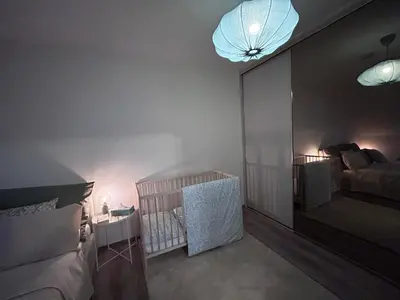 a bedroom with a crib and a large mirror at U Drahusky in Prague