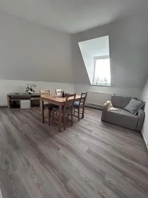a living room with a table and a couch at U Drahusky in Prague