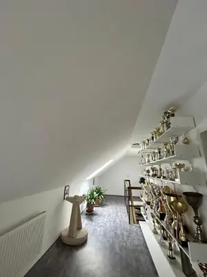 a room with a shelf of wine glasses at U Drahusky in Prague