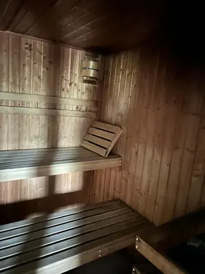 a wooden sauna with a bench in it at U Drahusky in Prague