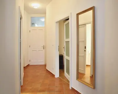 a mirror on a wall in a hallway at Green Park View apartment in Prague