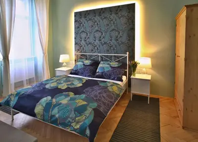 a bedroom with a bed with a large headboard at Green Park View apartment in Prague