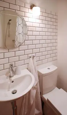 a white bathroom with a toilet and a sink at Green Park View apartment in Prague