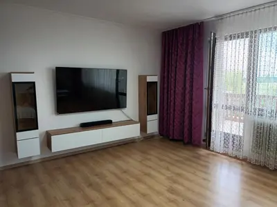 a living room with a flat screen tv on a wall at Byt v řadovém domě in Sadská