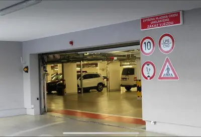 a parking lot with cars parked in a garage at Rezidence Garden Towers - studio s parkováním in Prague