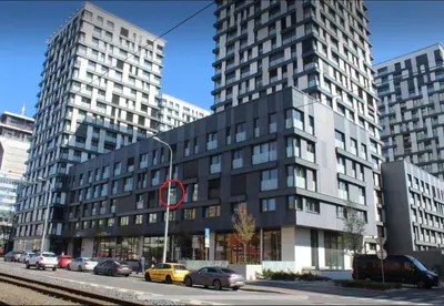 a tall building with cars parked in front of it at Rezidence Garden Towers - studio s parkováním in Prague