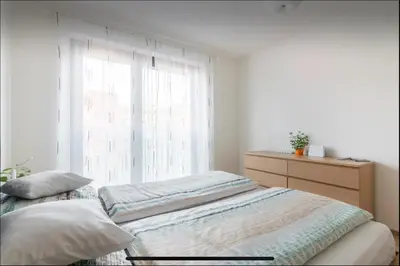 a bedroom with a bed and a window at Rezidence Garden Towers - studio s parkováním in Prague