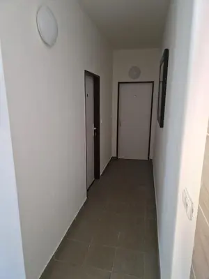 an empty hallway with two doors and a tile floor at Ubytování Louny in Louny