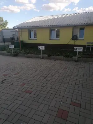 a yellow house with signs in front of it at Ubytování Louny in Louny