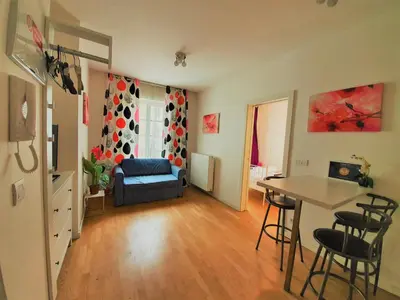 a living room with a blue couch and a table at Apartment Sophia in Prague