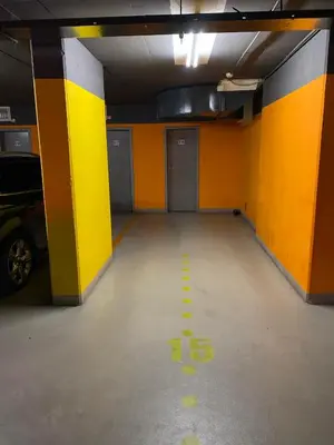 an empty parking garage with yellow and orange walls at Spacious Apartment near City Center with Balcony and Garage Parking in Prague