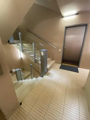 an empty hallway with stairs and a door in a building at Spacious Apartment near City Center with Balcony and Garage Parking in Prague